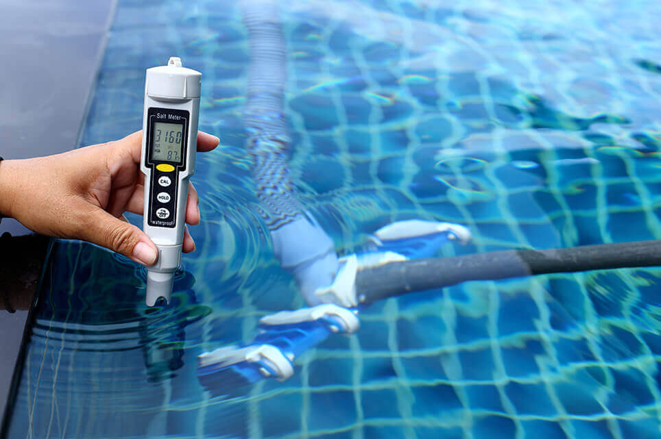 Checking chemical balance of swimming pool with digital instrument