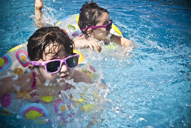 two children are happily swimming in the pool