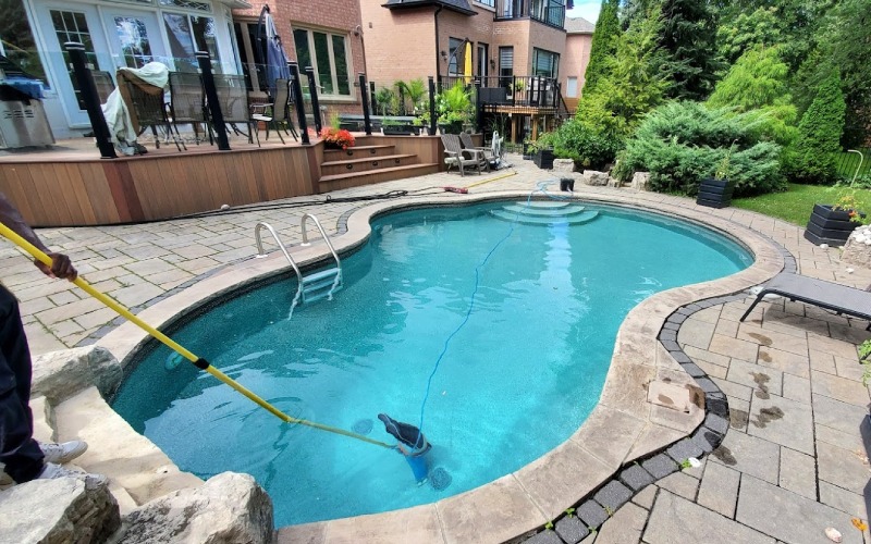 staff cleaning swimming pool